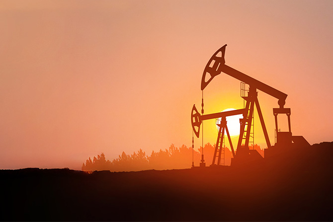 Oil rig machinery at sunset