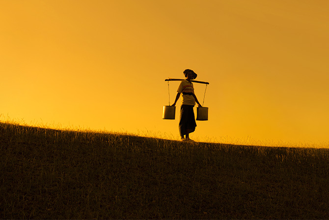 Person carrying buckets of water